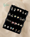 Black earring holder with various earrings on a beige fabric background, featuring the DIVA brand.